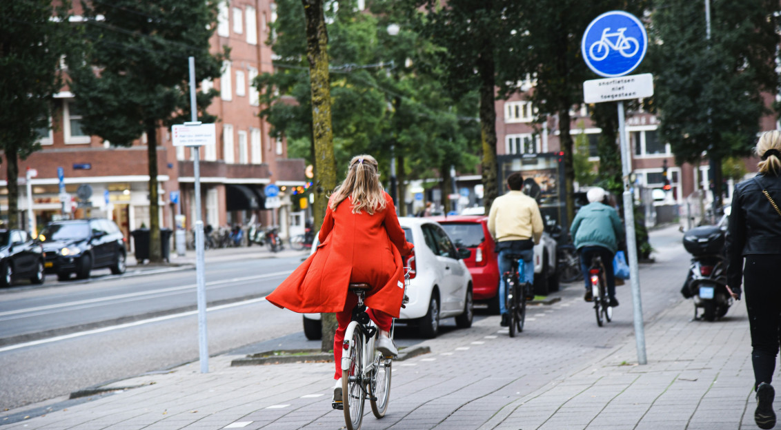 An illustrative photo of people riding bicycles on the street.